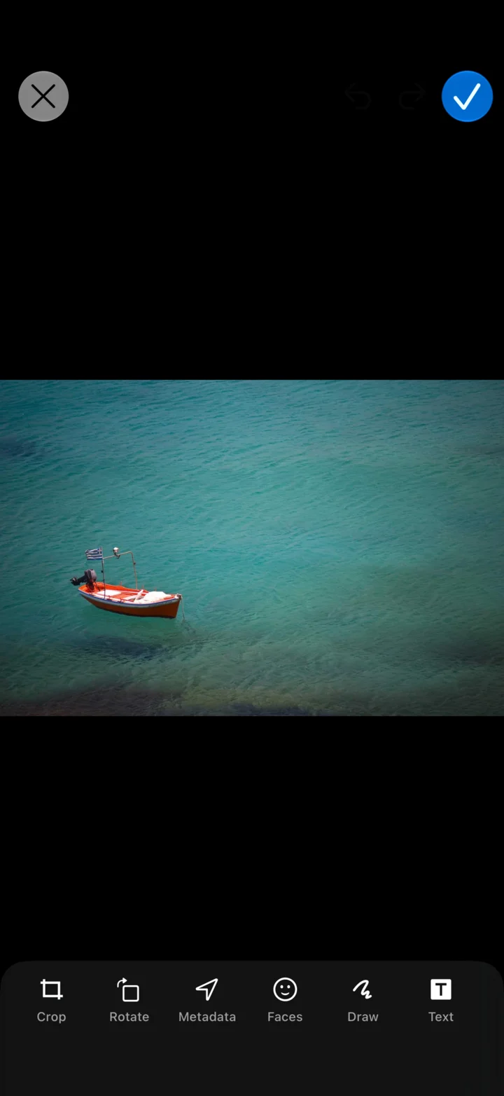 MaxVault’s photo editor with a boat photo and Crop, Rotate, Metadata, Faces, Draw and Text tools.